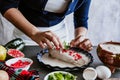 Mexican woman hands preparing and cooking chiles en nogada recipe with Poblano chili and ingredients, traditional dish in Puebla M