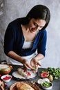 Mexican woman hands preparing and cooking chiles en nogada recipe with Poblano chili and ingredients, traditional dish in Puebla M