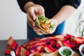 Mexican woman hands preparing tacos al pastor with sauce in Mexico city Royalty Free Stock Photo