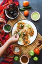 Mexican woman hands preparing tacos al pastor with sauce in Mexico city Royalty Free Stock Photo