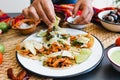 Mexican woman hands preparing tacos al pastor with sauce in Mexico city Royalty Free Stock Photo