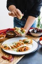 Mexican woman hands preparing tacos al pastor with sauce in Mexico city Royalty Free Stock Photo