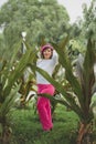 Mexican woman among plants wearing pink beret. Royalty Free Stock Photo