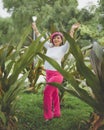 Mexican woman among plants wearing pink beret. Mexican woman portrait Royalty Free Stock Photo