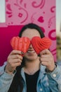 Mexican woman plays with two heart-shaped shell bread Royalty Free Stock Photo