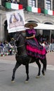 Mexican woman rider in the street with pink and black dress Royalty Free Stock Photo