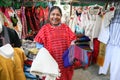 Mexican woman selling traditional mexican shawl and clothes in