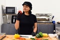 Mexican woman smelling bell pepper for cooking tacos in the kitchen Royalty Free Stock Photo