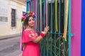 Mexican woman wearing embroidered dress and Lele doll headband. Royalty Free Stock Photo