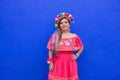 Mexican woman wearing embroidered dress and Lele doll headband. Royalty Free Stock Photo
