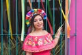 Mexican woman wearing embroidered dress and Lele doll headband. Royalty Free Stock Photo