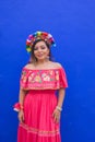 Mexican woman wearing embroidered dress and Lele doll headband. Royalty Free Stock Photo