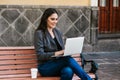 Mexican woman working with her laptop in a park bench in a colonial city in Latin America Royalty Free Stock Photo