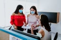 Mexican women working in business office or coworking while wearing medical face mask for social distancing in new normal