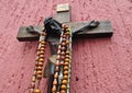 Mexican wooden crucifix with several rosaries Royalty Free Stock Photo