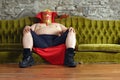 Mexican wrestler sitting on a couch Royalty Free Stock Photo