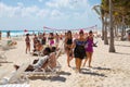 Mexico, Cancun. Group of young people relaxing, playing and sunbathing on the beach. Cancun Grand Pyramid entertaining complex Royalty Free Stock Photo