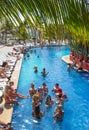 Mexico, Cancun. Group of young people relaxing and sunbathing in the pool. Cancun Grand Pyramid entertaining c Royalty Free Stock Photo