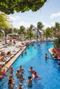 Mexico, Cancun. Group of young people relaxing and sunbathing in the pool. Cancun Grand Pyramid entertaining c Royalty Free Stock Photo