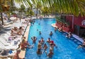 Mexico, Cancun. Group of young people relaxing and sunbathing in the pool. Cancun Grand Pyramid entertaining c Royalty Free Stock Photo