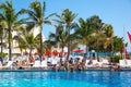 Mexico, Cancun. Group of young people relaxing and sunbathing in the pool. Cancun Grand Pyramid entertaining c Royalty Free Stock Photo