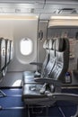 Inside of an empty commercial plane with grey leather seats close to emergency exit Royalty Free Stock Photo