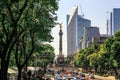 Big city street with traffic and monument in a back side