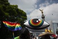 King`s crown, Rainbow flag and big eye among people marching in avenue de la Reforma next to winged victory in Mexico City for LG