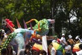 Multicoloured Alebrije among rainbow umbrellas and protesters in the march for LGBTTTI pride