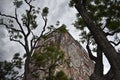 Mexico City, Mexico June 2 2019 UNAM Central Library seen from below with trees around, cloudy sky
