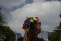 Woman proudly wearing rainbow-colored headdress and sunglasses in the great March for LGBTTI pride in Mexico