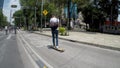 Young man on a skateboard riding with cyclists