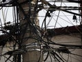 Mexico City Messed up power lines and connection cables. Many tangled wires on electric poles in the city Royalty Free Stock Photo
