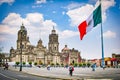 Mexico City, Mexico - April 12, 2012. Main square Zocalo with cathedral and big Mexican flag Royalty Free Stock Photo
