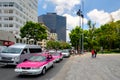 Urban scene with traditional pink taxis in downtown Mexico City