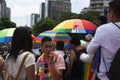 People shading themselves from the sun with rainbow coloured umbrellas at the march for LGBTTI pride in Mexico city under natural