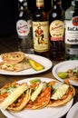 Mexico City, Mexico - September 14, 2020 - Mexican tacos, Mexican food concept. Famous bottles of alcoholic beverages on the bar t Royalty Free Stock Photo