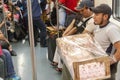 Mexico DF State/Mexico 12/27/2009. Street seller sitting inside subway carry a basket with some desserts Subway station Mexico Cit