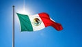 mexico flag on the flagpole in the sky with the sun shining through it Royalty Free Stock Photo