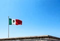mexico flag on a pole waving in a blue sky background Royalty Free Stock Photo