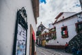 MEXICO - SEPTEMBER 22: Narrow street and a church dome in the ba Royalty Free Stock Photo