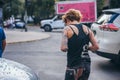 MEXICO - SEPTEMBER 19: Tattooed woman walking next to a car with a broken windshield due to fallen debris