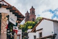 MEXICO - SEPTEMBER 22: Towers of the Taxco Cathedral and traditional white and red buildings, September 22, 2017 in Taxco, Mexico Royalty Free Stock Photo