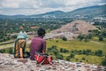 MEXICO - SEPTEMBER 21: Two young people sitting and watching the Pyramid of the moon