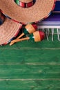 Mexico sombrero border mexican maracas old green wood background