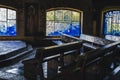 View of the maera benches and a stained glass window in the background inside the chapel of