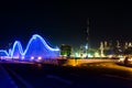 Meydan bridge and Dubai cityscape at night