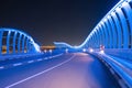 Meydan Bridge and street road or path way on highway with modern architecture buildings in Dubai Downtown at night, urban city at