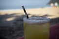 Mezcal Margarita made with fresh lime juice served in a glass with a paper straw on the beach Royalty Free Stock Photo