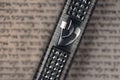 Mezuzah case laying on blurred parchment with Jewish prayer Shema Yisrael in hebrew, mezuzah commandment